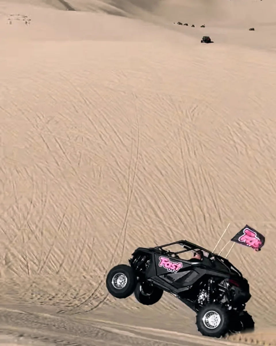 FastUTV UTV and flag riding across a sand dune