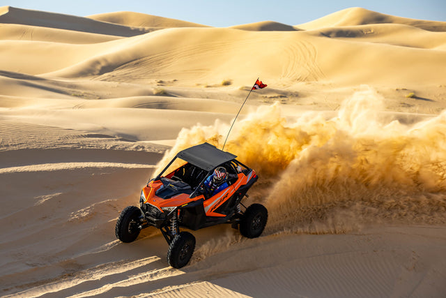 2023 Polaris RZR Turbo R driving in the dunes, entire vehicle visible