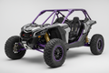 maverick x3 2 seat side-by-side with a purple roll cage