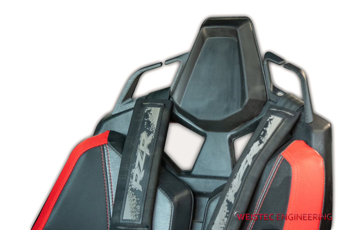 Weistec harness strap guides shown installed on a seat; seat and harness shown for reference