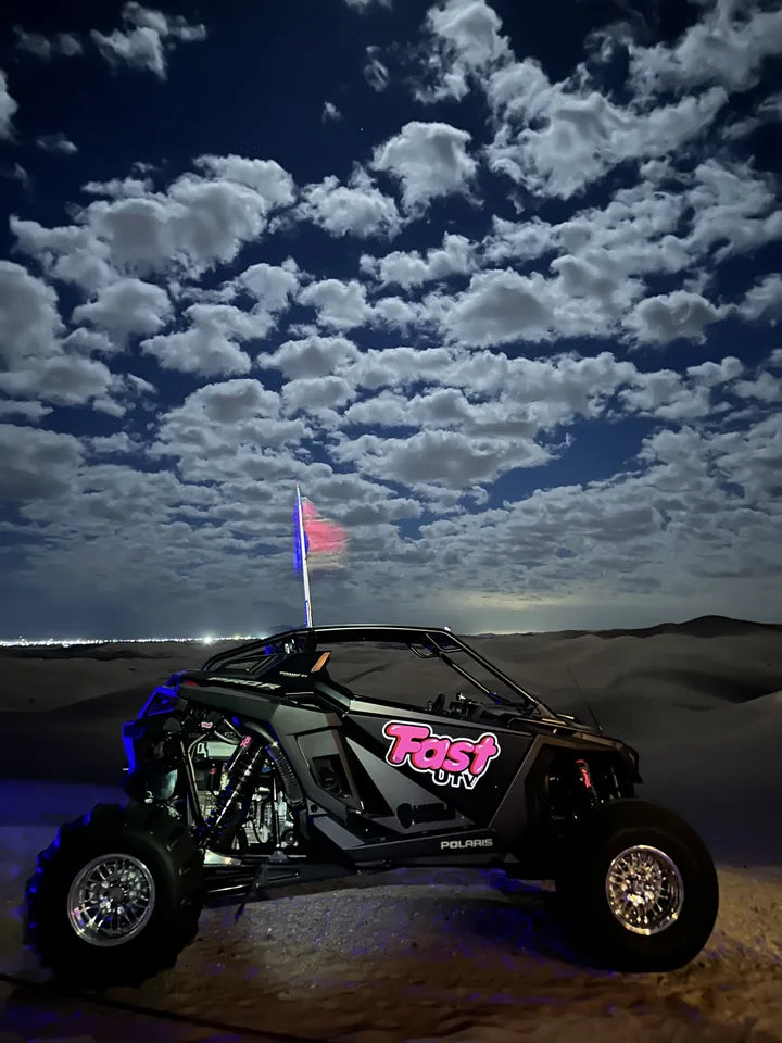 FastUTV dune build beneath clouds in the night sky