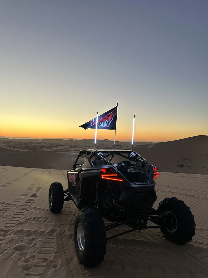 FastUTV dune build and flag against the sunset