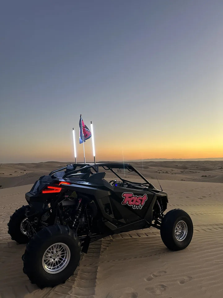 FastUTV dune build beside tracks at dusk